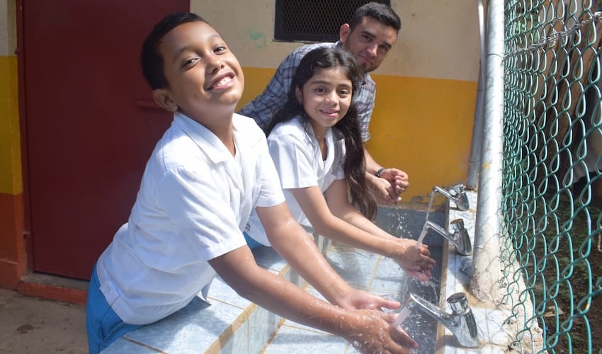 A group of people washing hands together