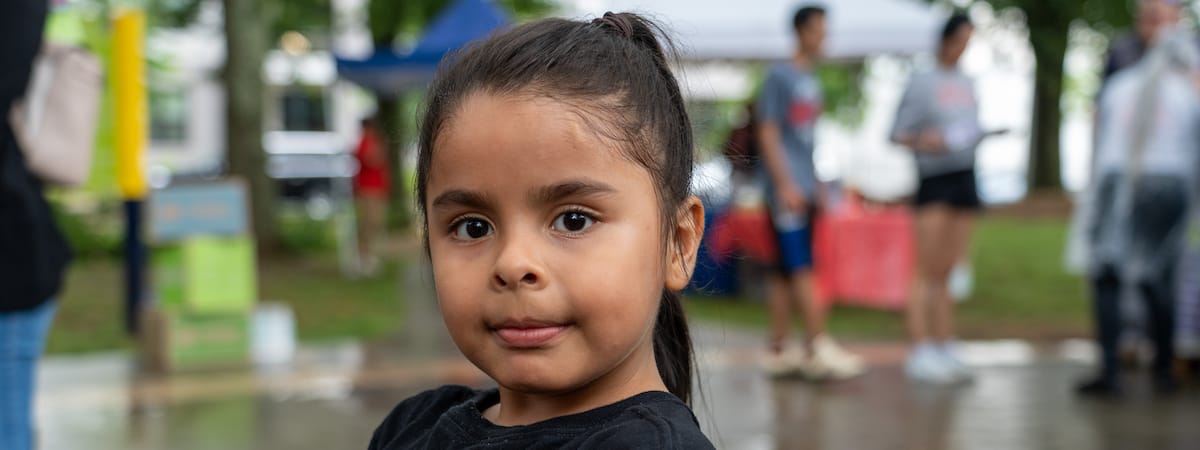 A girl standing outdoors at an event
