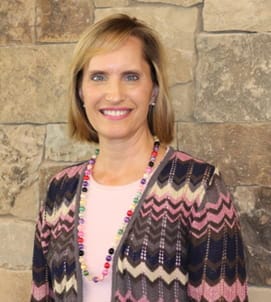 A portrait of a woman in front of a stone wall