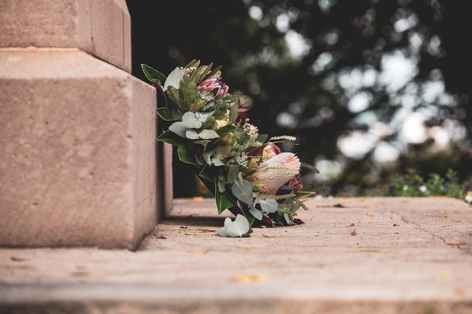 A wreath of flowers sitting against bricks
