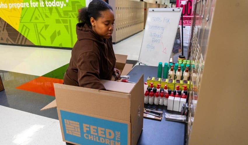 A woman getting supplies out of a box